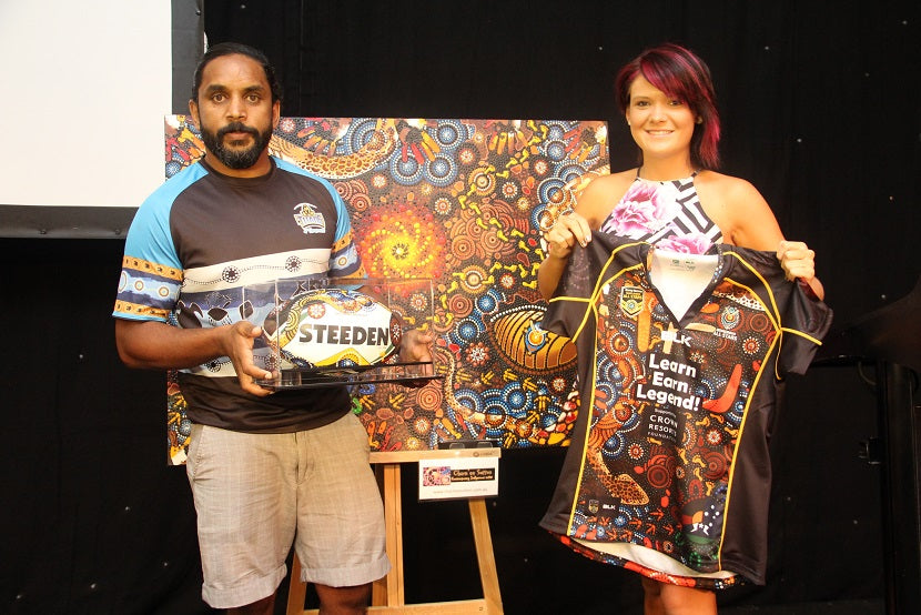 Preston Campbell gets presented with a painted Chern'ee Sutton football
