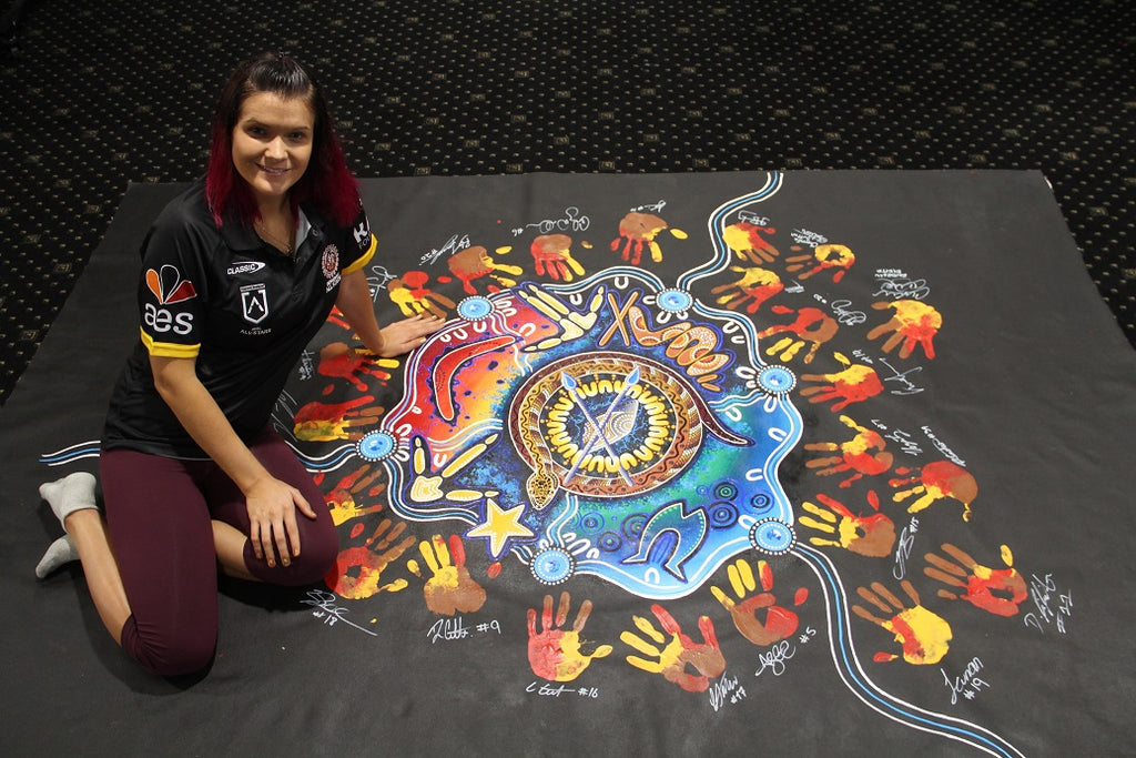 Chern'ee paints with the NRL's Indigenous All Stars